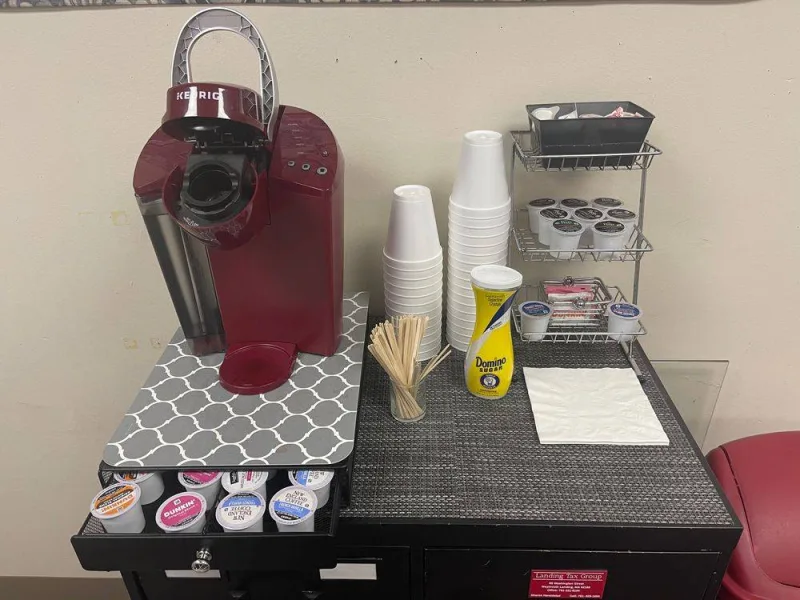 Coffee station at the office with a Keurig, cups and treats for clients